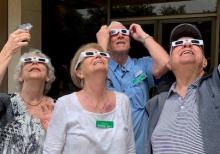 members with eclipse glasses