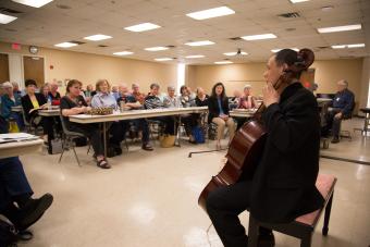 People listening to cellist play